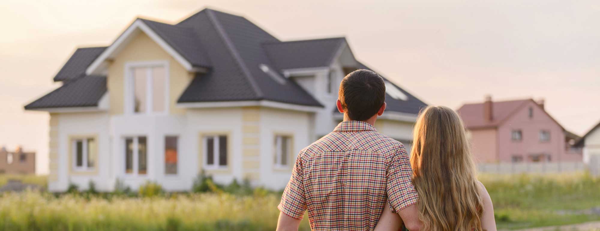 Young Couple in front of House